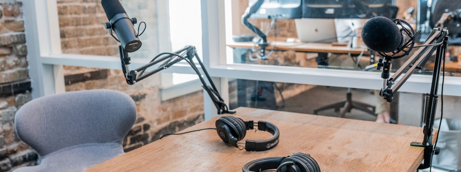 two black headphones on brown wooden table